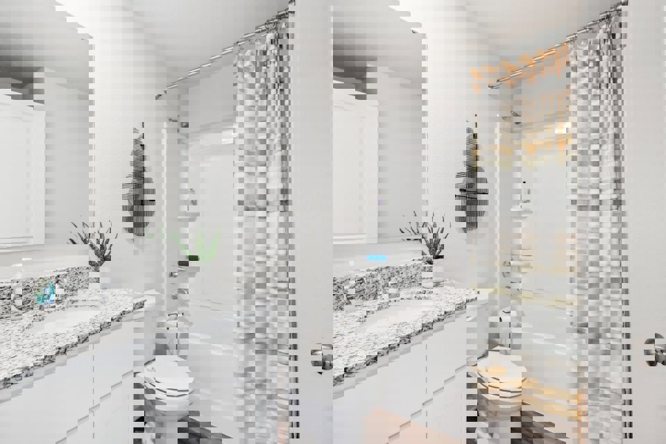 A bathroom with a shower and toilet.