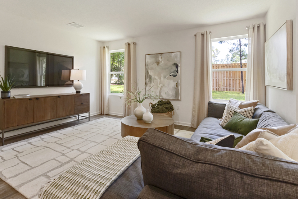 A living room with a couch and a table.