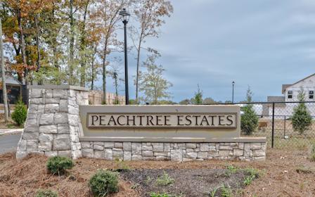 A sign on a stone wall.