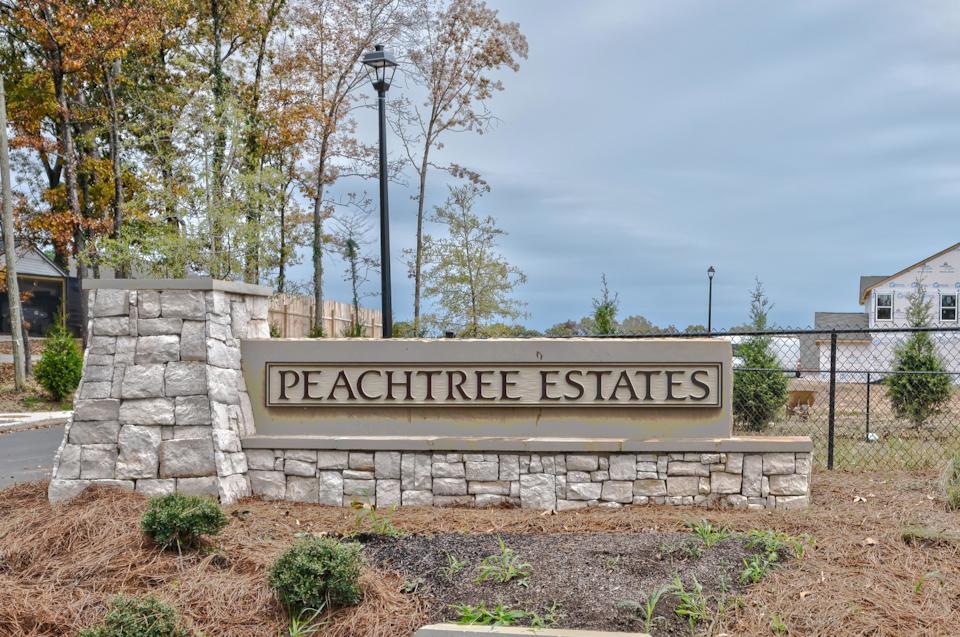 A sign on a stone wall.