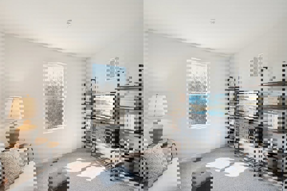 A living room with a tv and shelves.