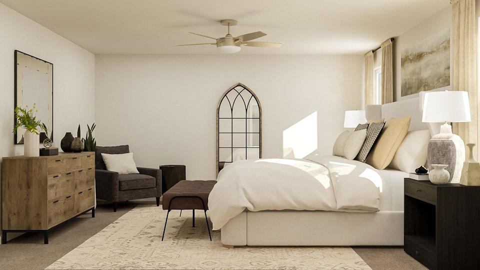 A large bedroom with a bed and a chair.