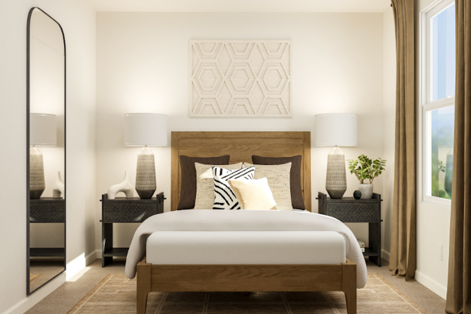 A bed with a white bed spread.