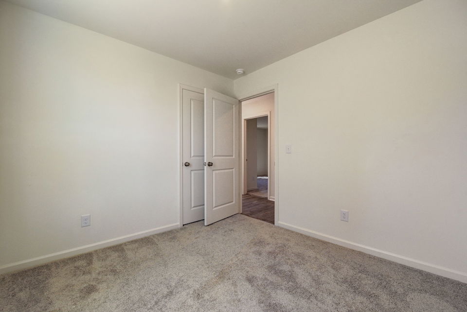 A hallway with white doors.