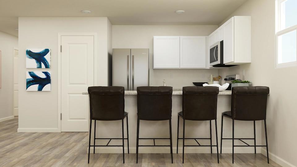 A kitchen with a table and chairs.