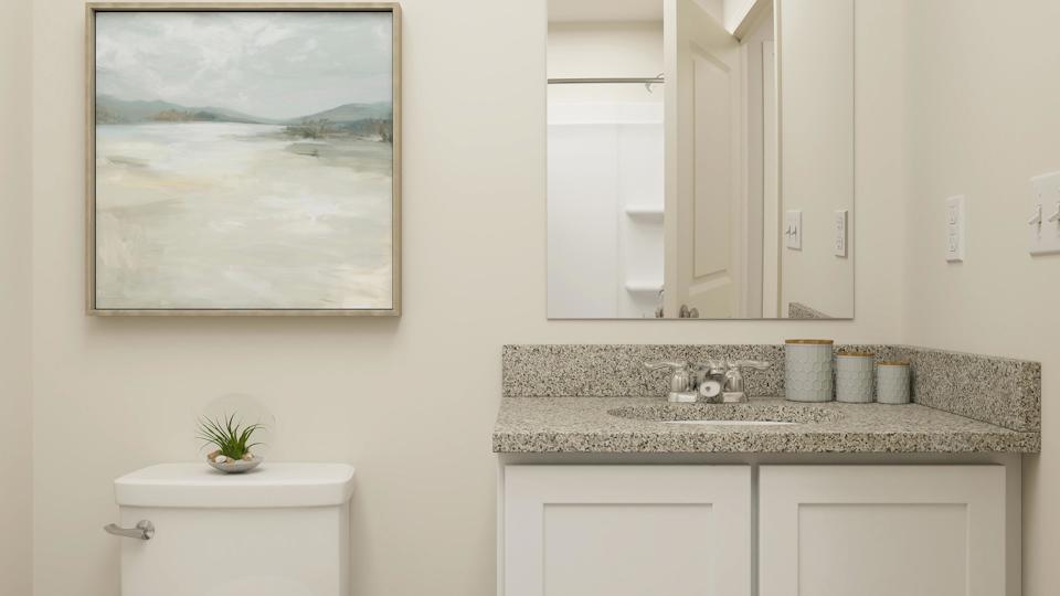 A bathroom with a large painting on the wall.