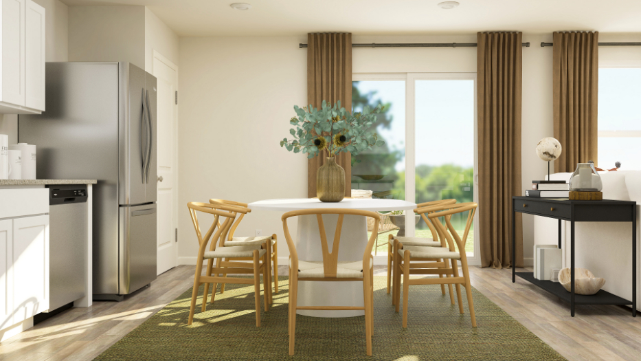 A kitchen with a table and chairs.