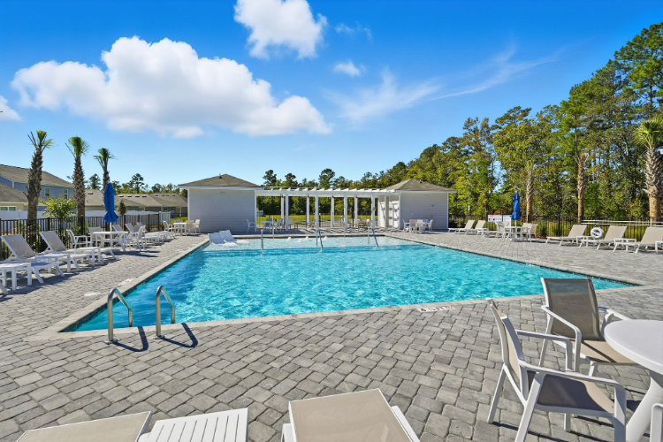 A swimming pool with chairs around it.