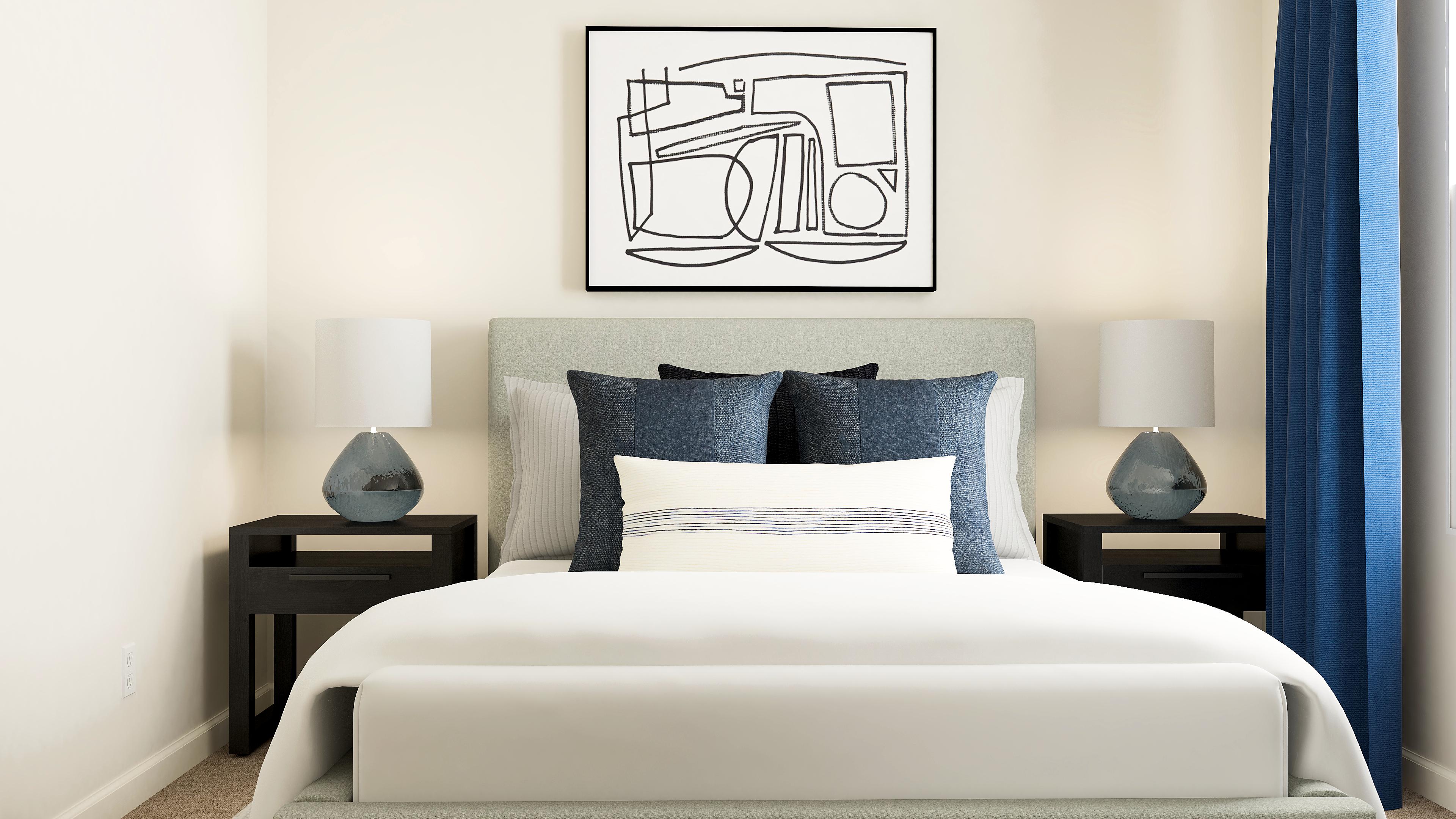 A bed with a white bed spread.