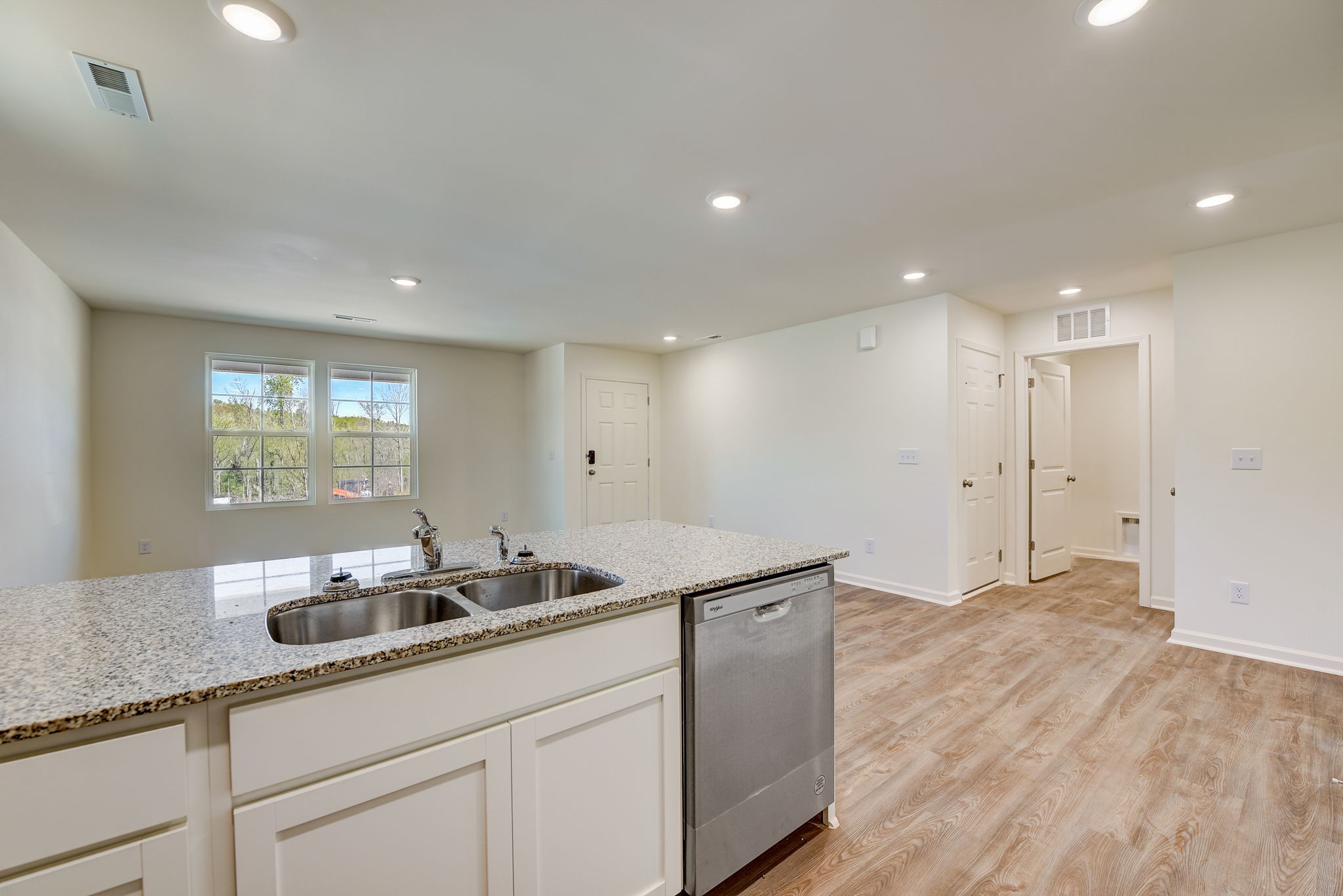 A kitchen with white cabinets.