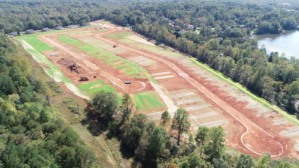 A road with trees and grass.