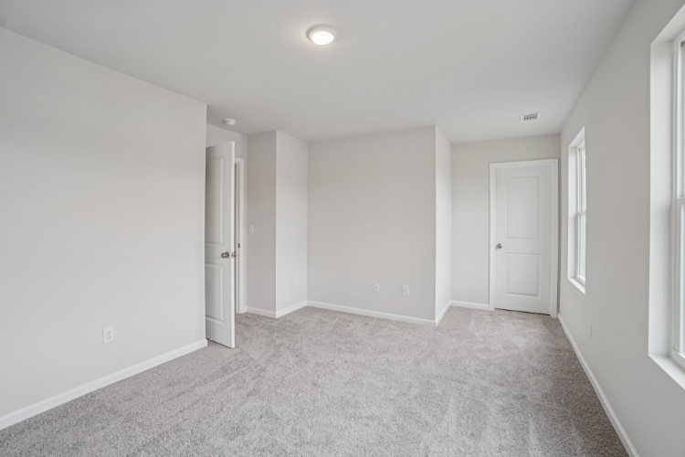 A hallway with white doors.
