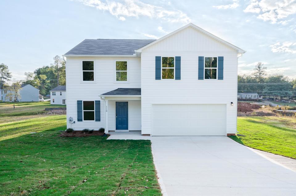 A white house with blue shutters.